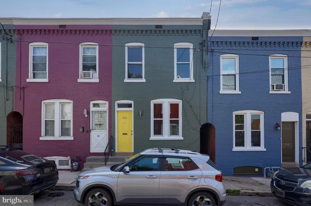 a front view of a building with parking space