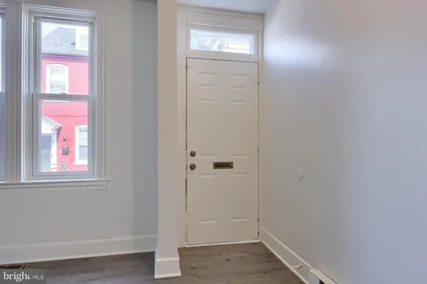 an empty room with windows and closet
