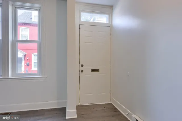 an empty room with windows and closet