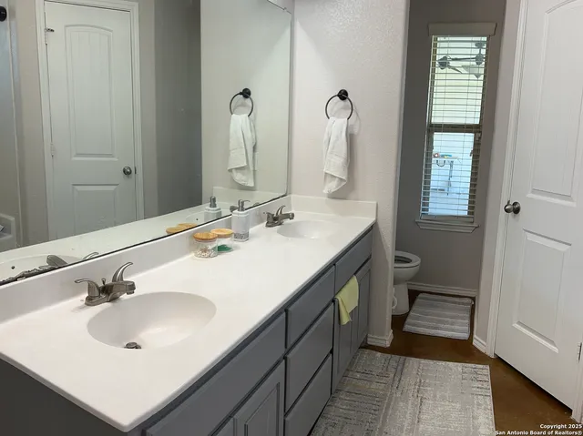 a bathroom with a sink double vanity and a mirror
