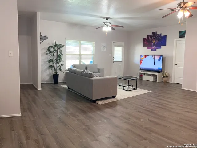 a living room with furniture and a chandelier