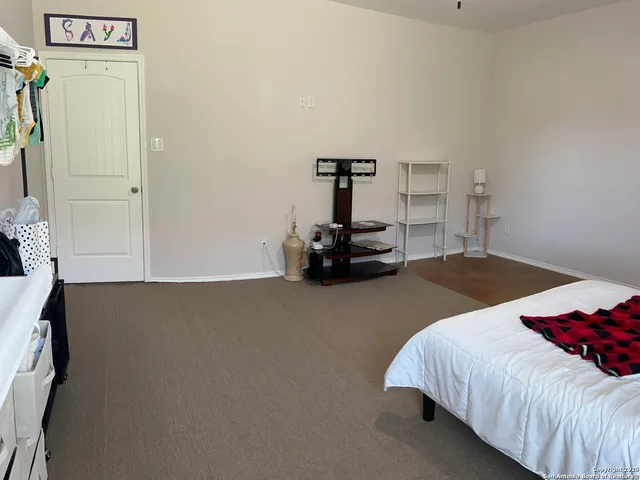 a bedroom with a bed and a car