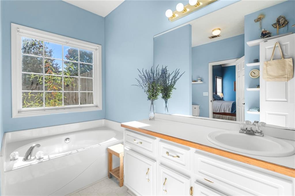 826 Hampton Way Canton, GA 30115 - Photo 13 of 17 a bathroom with a bathtub and a sink