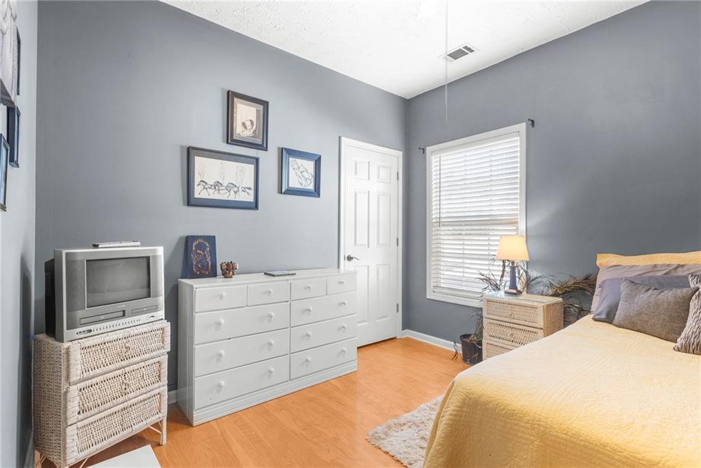 826 Hampton Way Canton, GA 30115 - Photo 14 of 17 a bedroom with a bed and a television