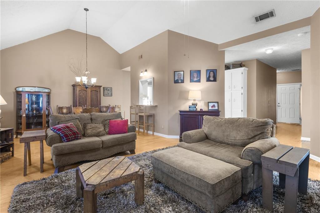 826 Hampton Way Canton, GA 30115 - Photo 6 of 17 a living room with furniture and a chandelier