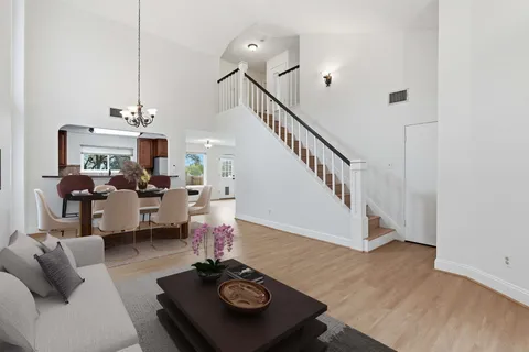 a living room with furniture and wooden floor