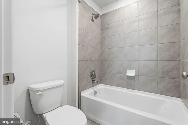 a bathroom with a double vanity sink mirror double and a bathtub