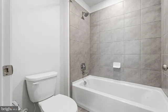a bathroom with a double vanity sink mirror double and a bathtub