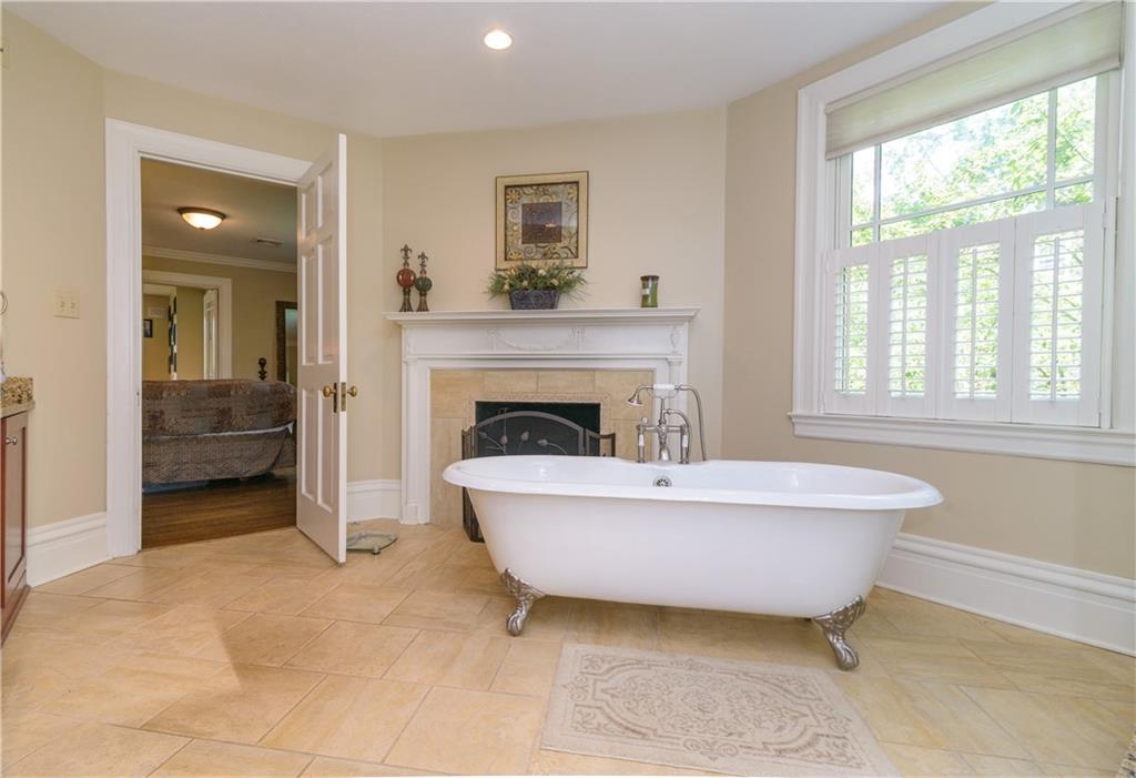 403 Quaker Road Sewickley, PA 15143 - Photo 14 of 24 a living room with a fireplace and a bathtub