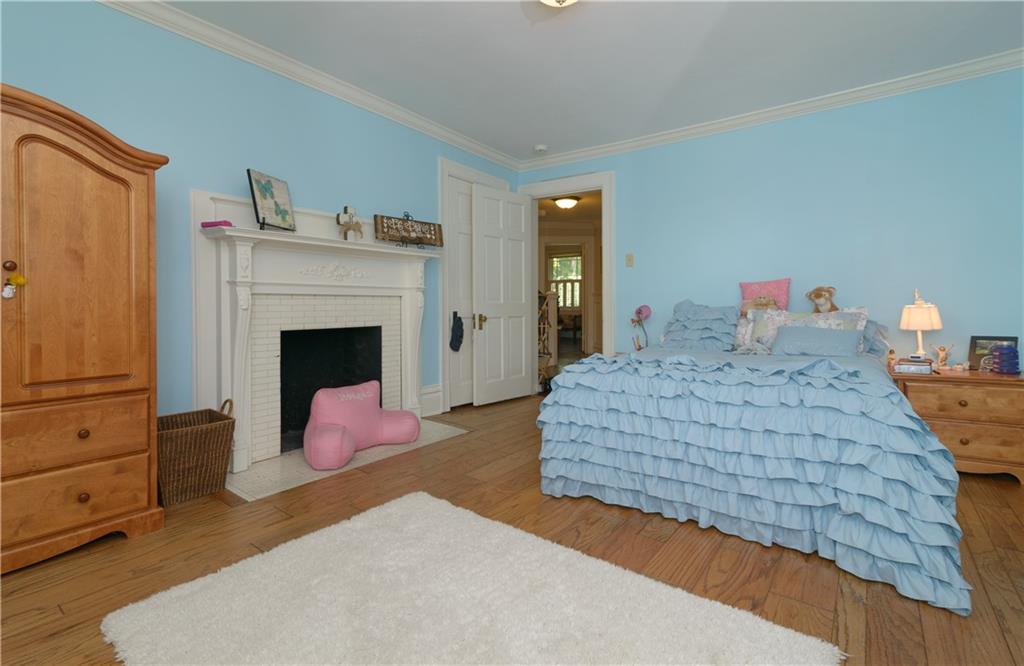 403 Quaker Road Sewickley, PA 15143 - Photo 17 of 24 a bedroom with a bed and a fireplace