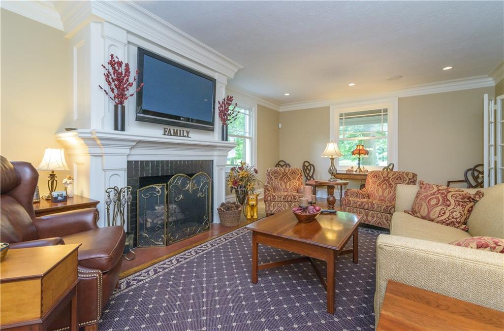 403 Quaker Road Sewickley, PA 15143 - Photo 5 of 24 a living room with furniture a flat screen tv and a fireplace