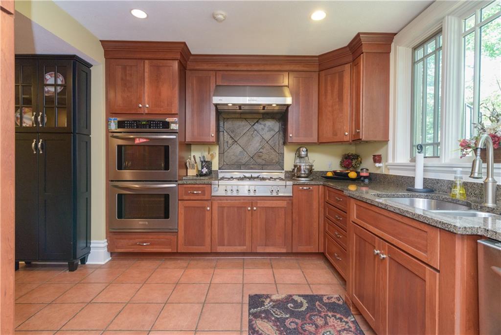 403 Quaker Road Sewickley, PA 15143 - Photo 10 of 24 a kitchen with stainless steel appliances granite countertop a stove a sink and a refrigerator