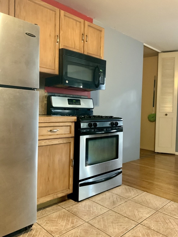 109 Regency Park Drive, Unit 109 Agawam, MA 01001 - Photo 1 of 17 a kitchen with stainless steel appliances a stove a microwave and a refrigerator
