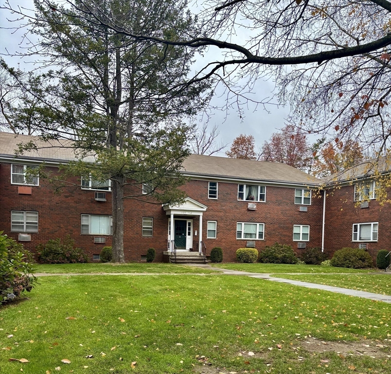 109 Regency Park Drive, Unit 109 Agawam, MA 01001 - Photo 11 of 17 front view of a house with a yard