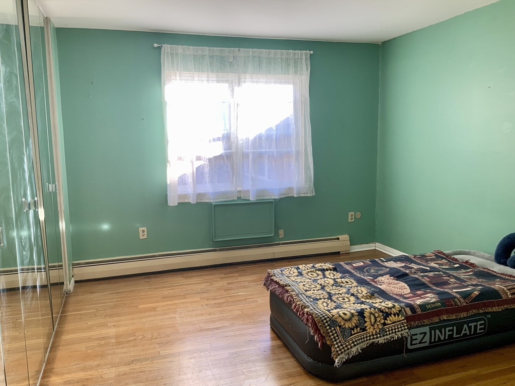 109 Regency Park Drive, Unit 109 Agawam, MA 01001 - Photo 9 of 17 a bedroom with a bed and a window