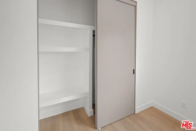 a view of an empty room with closet