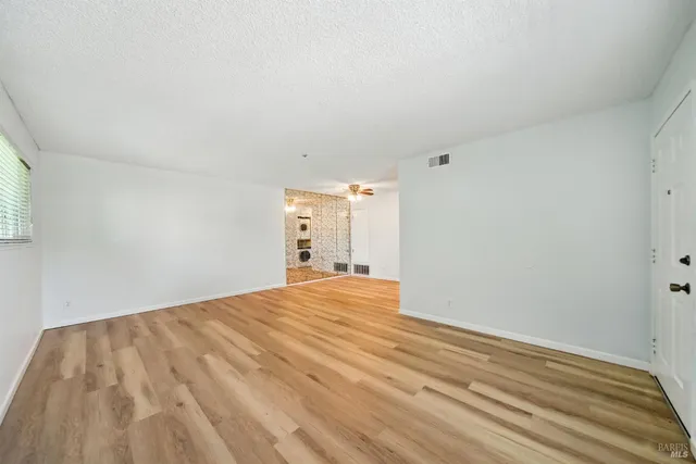 a view of room with window and ceiling fan