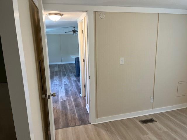5259 Fm 156 Street North, Unit 17 Krum, TX 76249 - Photo 11 of 12 a view of a hallway with wooden floor