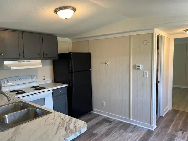 a kitchen with a refrigerator and a sink