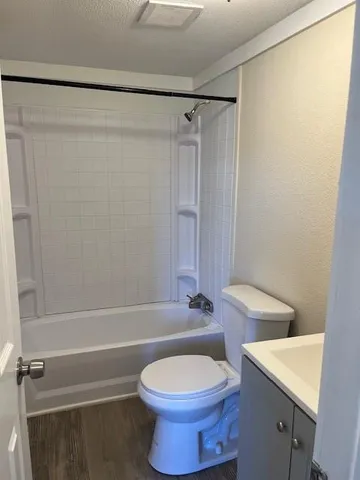 a bathroom with a toilet a sink and bathtub