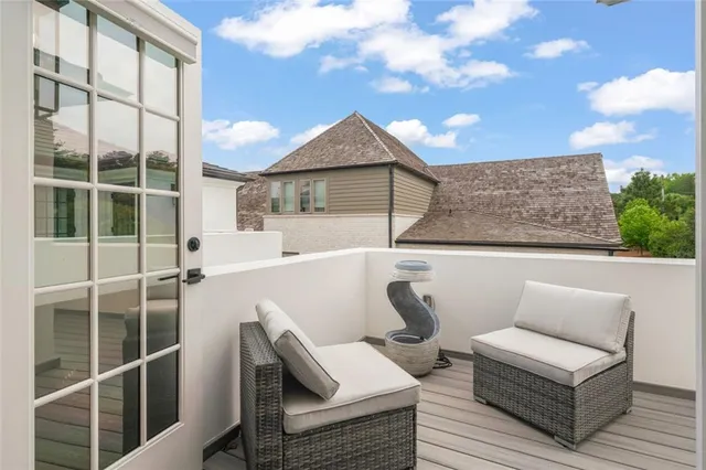 a view of a terrace with couches and wooden fence