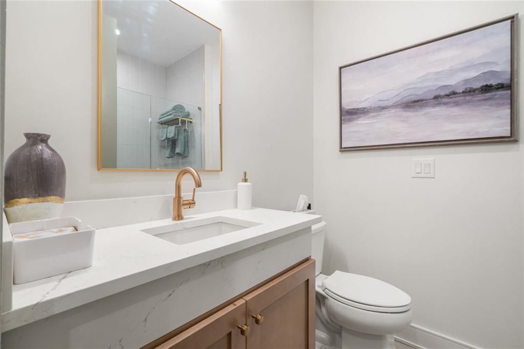 172 High Street Fayetteville, GA 30214 - Photo 17 of 21 a bathroom with a sink a toilet and a mirror