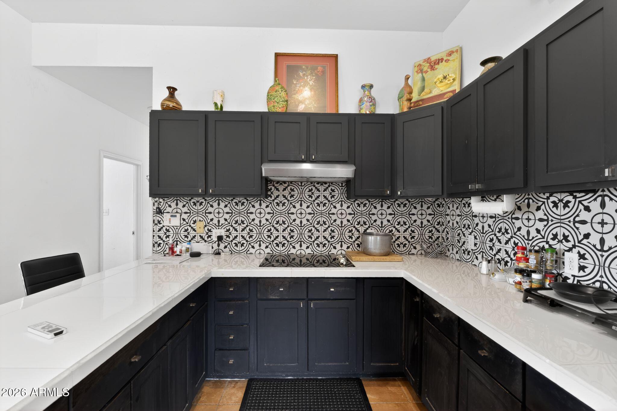 277 Círculo Silva Rio Rico, AZ 85648 - Photo 13 of 34 a kitchen with a sink and cabinets