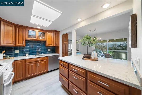 a kitchen with sink and view of living room