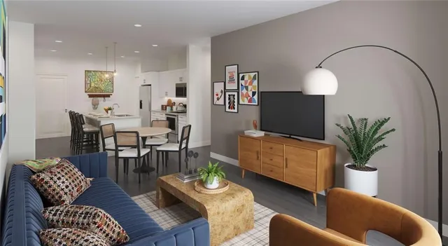a living room with furniture potted plant and a mirror