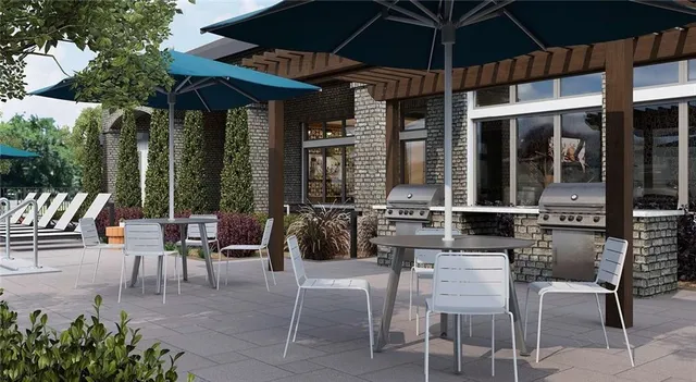 a view of a patio with a table and chairs under an umbrella