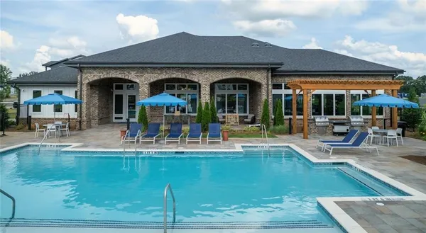 a view of a swimming pool with outdoor seating