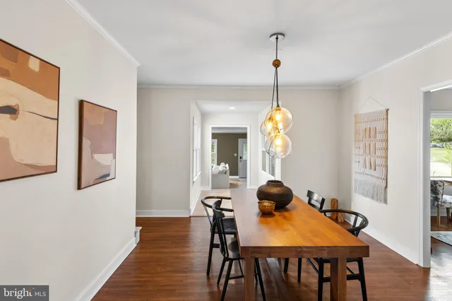 a dining room view with a table and chairs