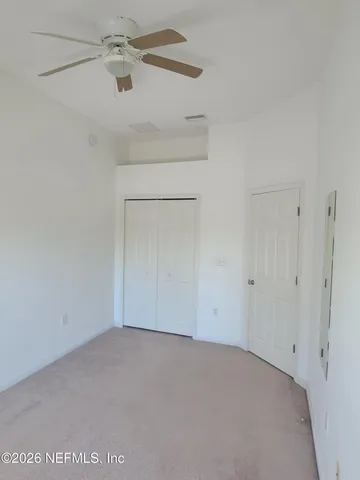 an empty room with a fan