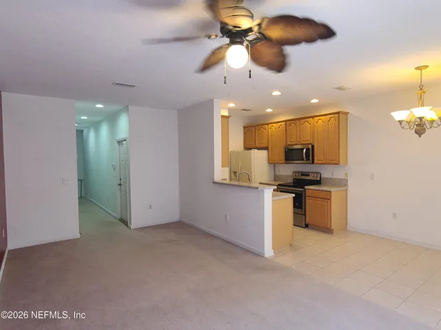 a view of kitchen with a sink and stainless steel appliances