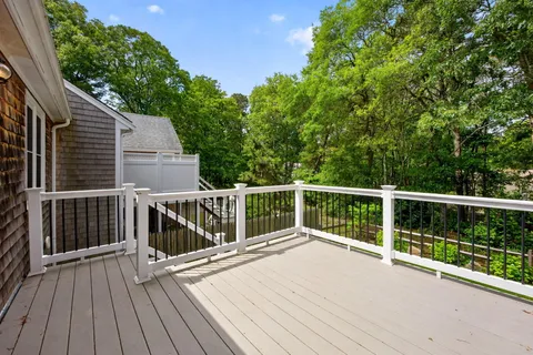 a view of balcony with wooden floor and fence