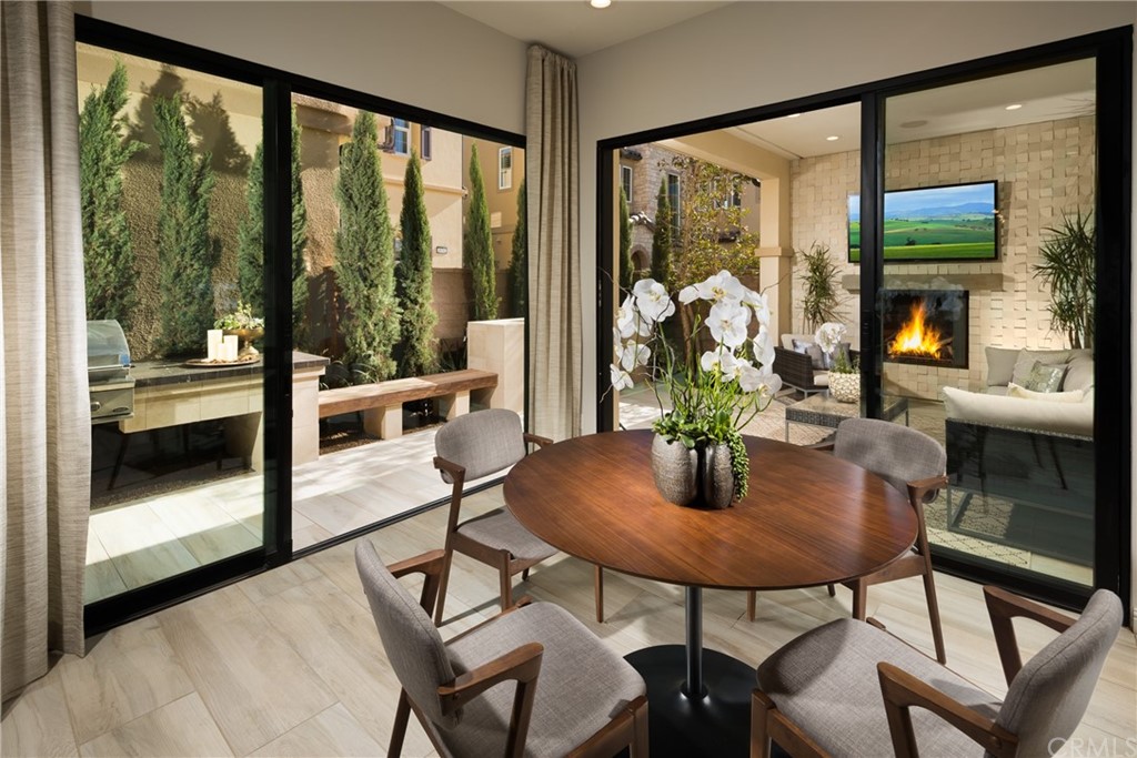 20740 Bur Oak Circle Porter Ranch, CA 91326 - Photo 5 of 10 a dining room with furniture a chandelier and glass door