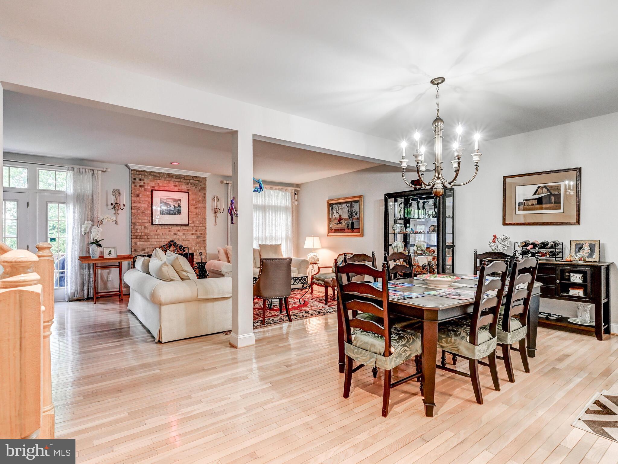 111 River Oaks Circle Baltimore, MD 21208 - Photo 11 of 35 a view of a dining room with furniture a chandelier and wooden floor