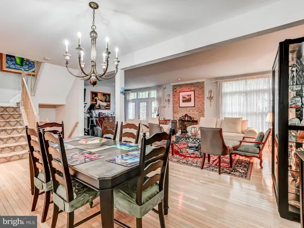 a view of a dining room with furniture wooden floor and chandelier