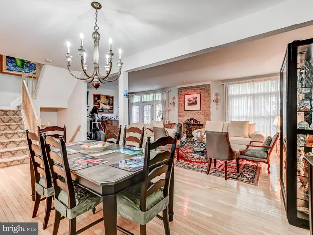 a view of a dining room with furniture wooden floor and chandelier