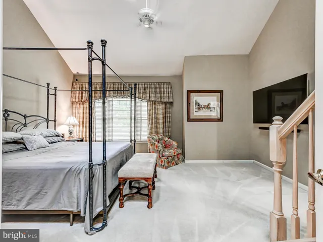 a bedroom with furniture and a flat screen tv
