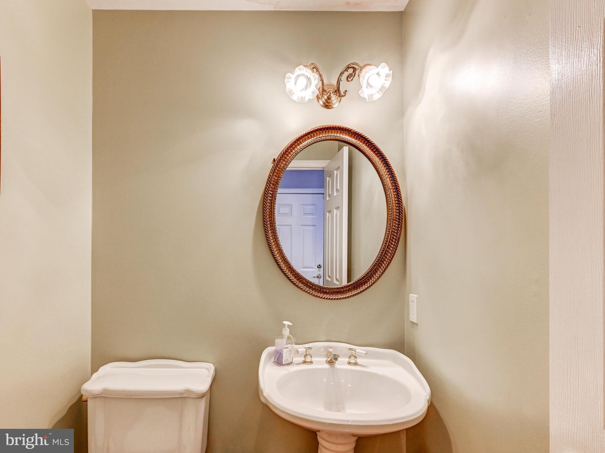 111 River Oaks Circle Baltimore, MD 21208 - Photo 29 of 35 a bathroom with a sink and a mirror