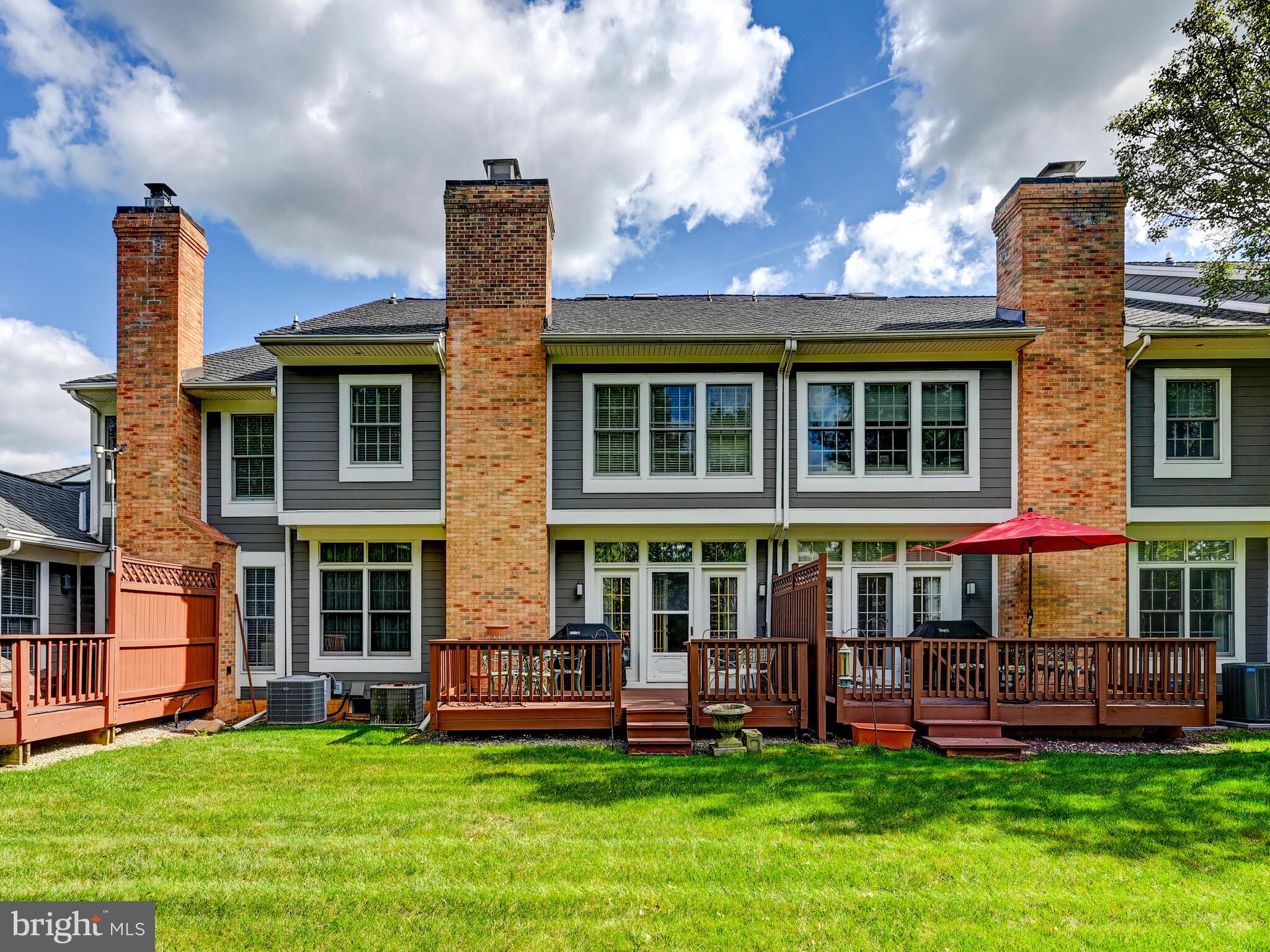 111 River Oaks Circle Baltimore, MD 21208 - Photo 34 of 35 a front view of a house with a yard table and chairs
