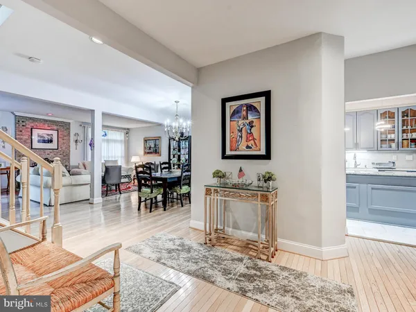 a living room with furniture a rug and kitchen view