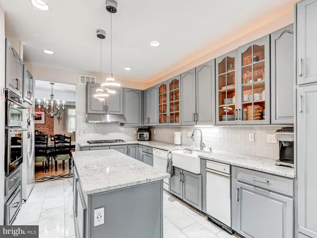 a kitchen with a sink counter top space appliances and cabinets