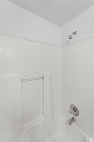 2600 North Hill Field Road, Unit 103A Layton, UT 84041 - Photo 23 of 31 White tub and shower combination with chrome fixtures