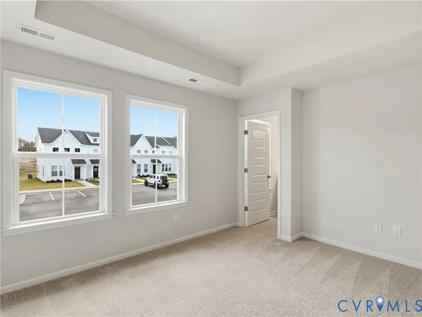 an empty room with windows and closet