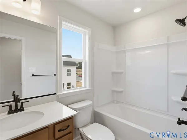 a bathroom with a sink toilet a mirror and shower