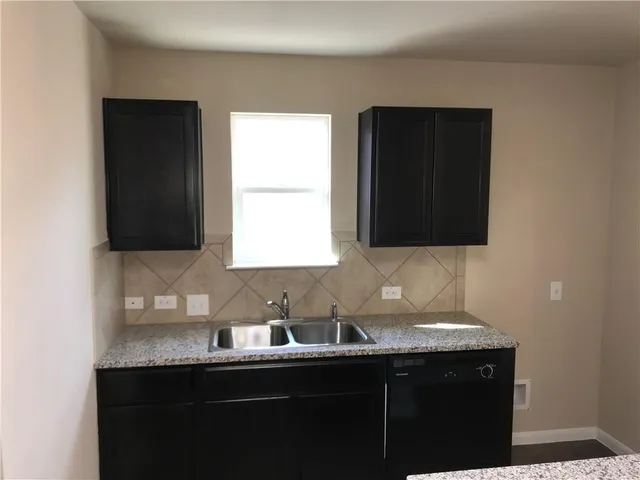 a kitchen with a sink and cabinets