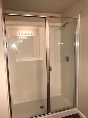 a bathroom with a glass shower door
