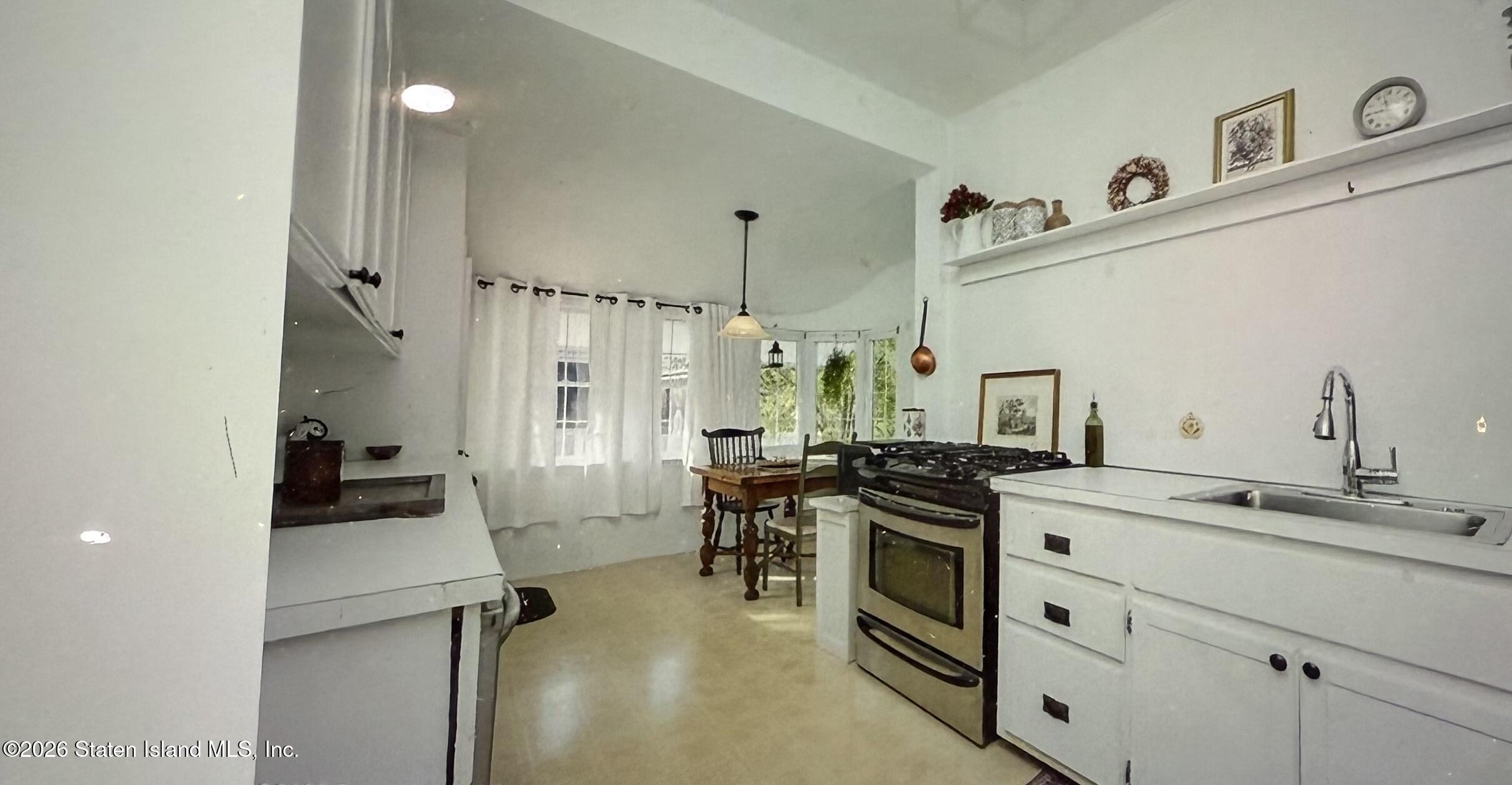 111 David Street Staten Island, NY 10308 - Photo 12 of 38 a kitchen with a sink stove and cabinets